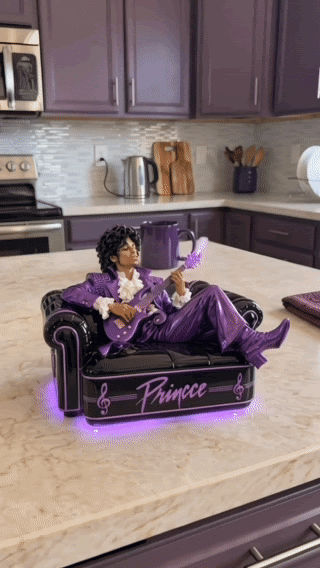 Animated demonstration of the diffuser releasing mist from the guitar with purple light beneath the sofa